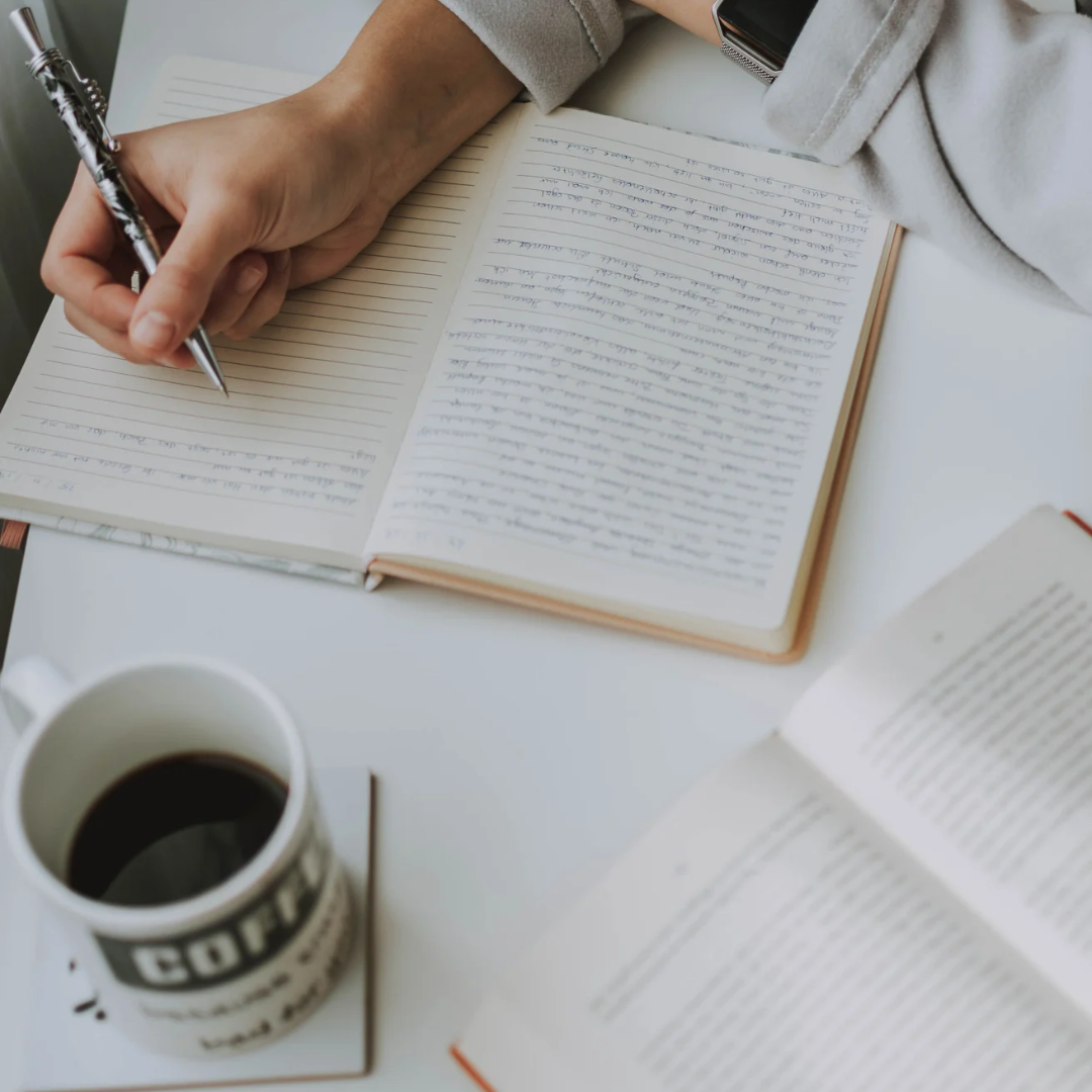 Writing by the table with a coffee on the side