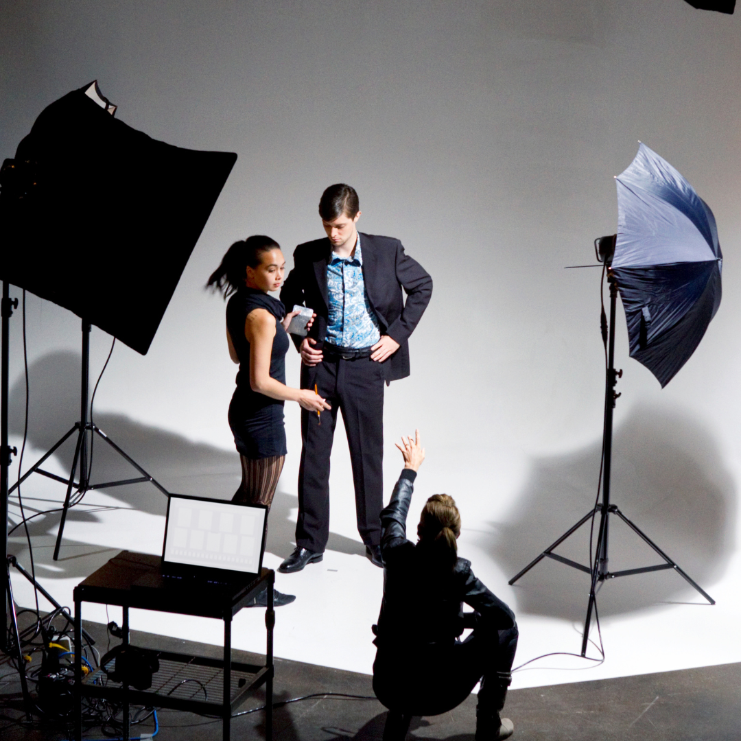 Confident business standing for a photoshoot of his branding with crew around him