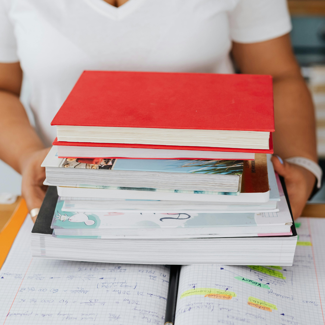 Photo of books and guides stacked to help you write your book