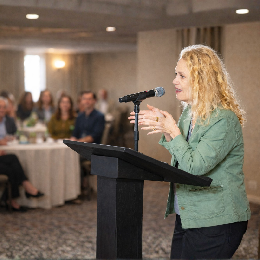 An author speaking in front of audiences about her book