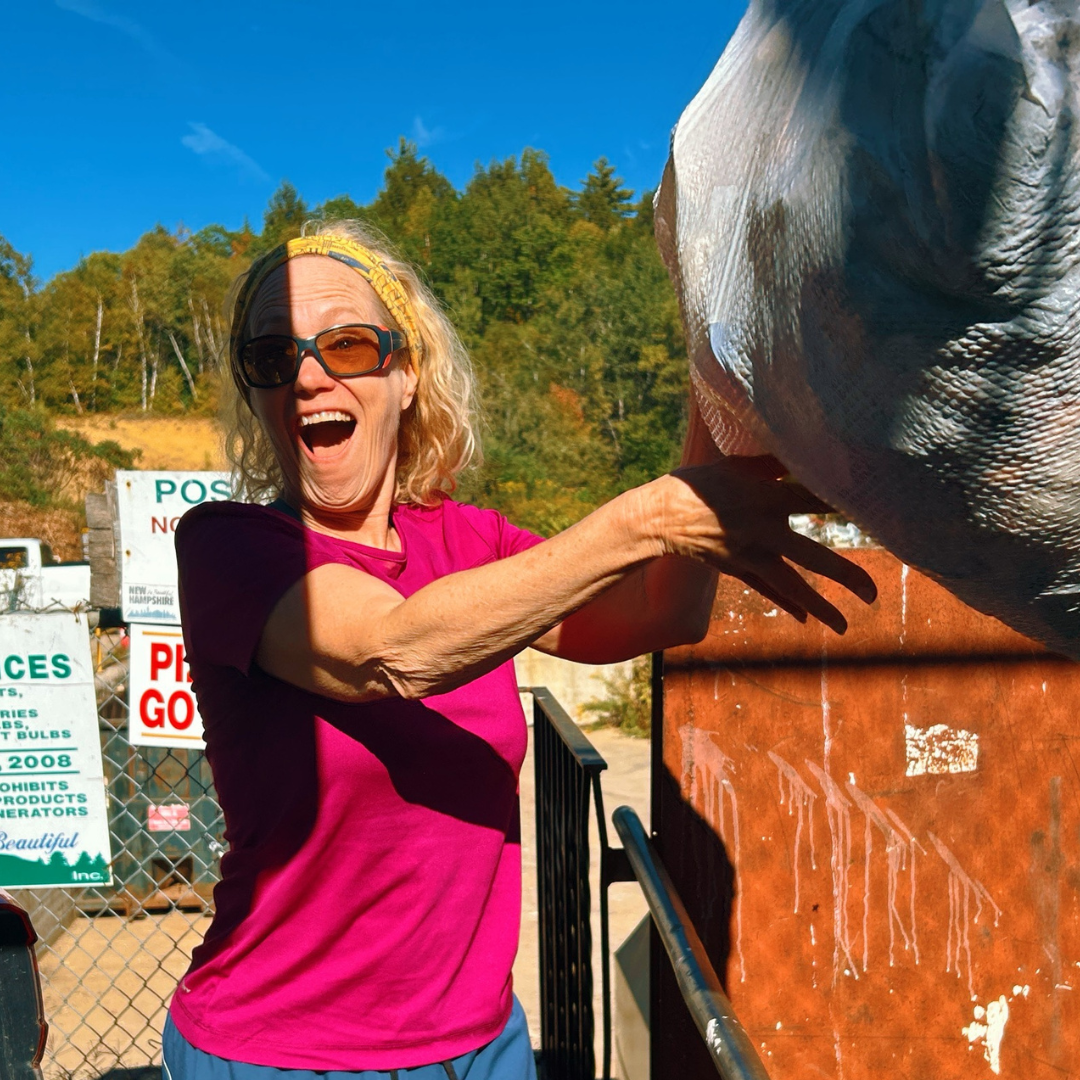 Photo of Ann taking trash